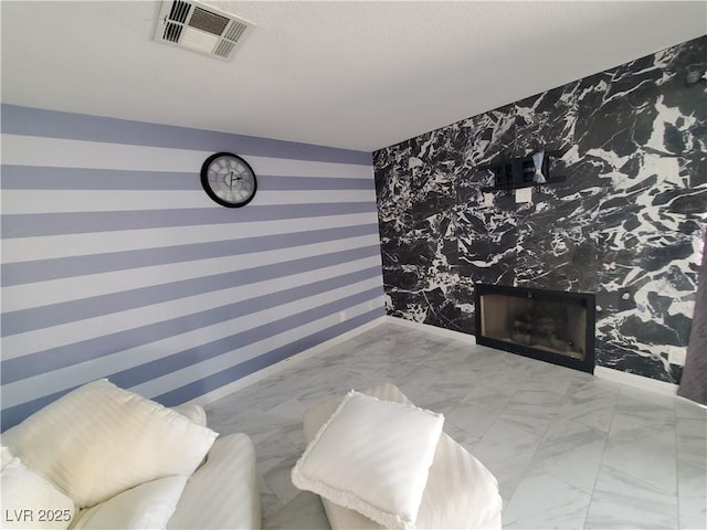 bedroom with baseboards, marble finish floor, visible vents, and wallpapered walls