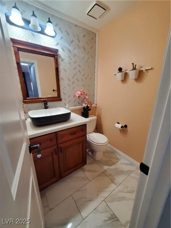 bathroom featuring marble finish floor, vanity, toilet, and baseboards