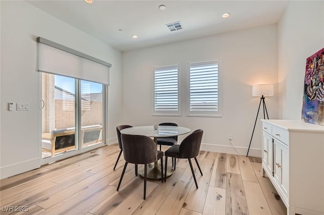 dining room featuring light wood-type flooring, visible vents, baseboards, and recessed lighting