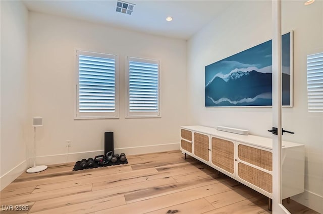 interior space featuring recessed lighting, visible vents, baseboards, and wood finished floors