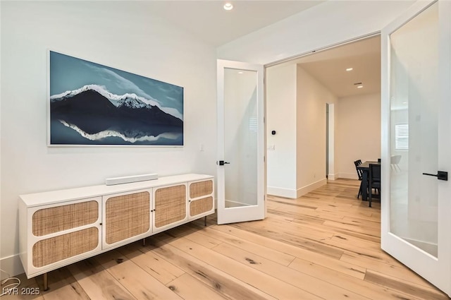 corridor featuring recessed lighting, french doors, baseboards, and wood-type flooring