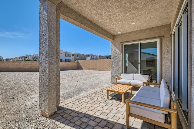 view of patio featuring an outdoor living space and a fenced backyard