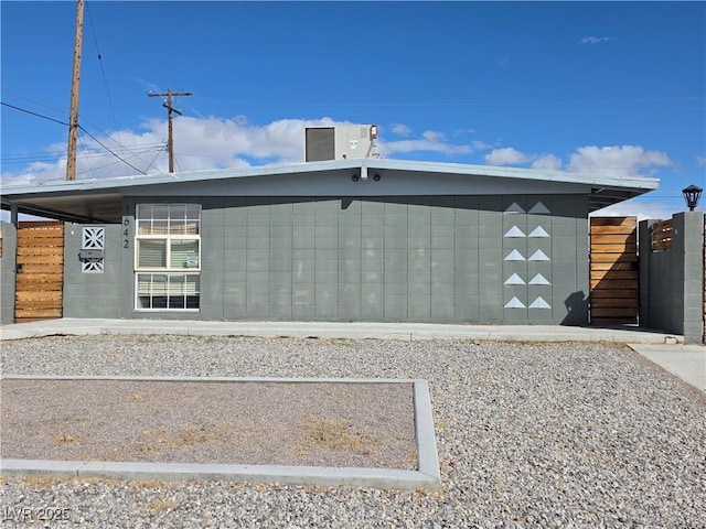 exterior space featuring central AC and fence