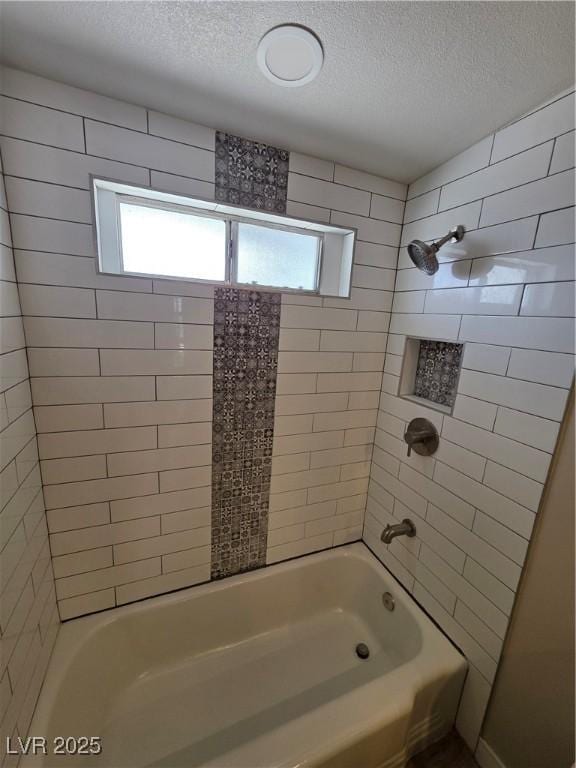 bathroom with a wealth of natural light, a textured ceiling, and shower / bathtub combination