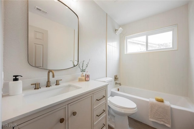 bathroom featuring toilet, washtub / shower combination, visible vents, and vanity