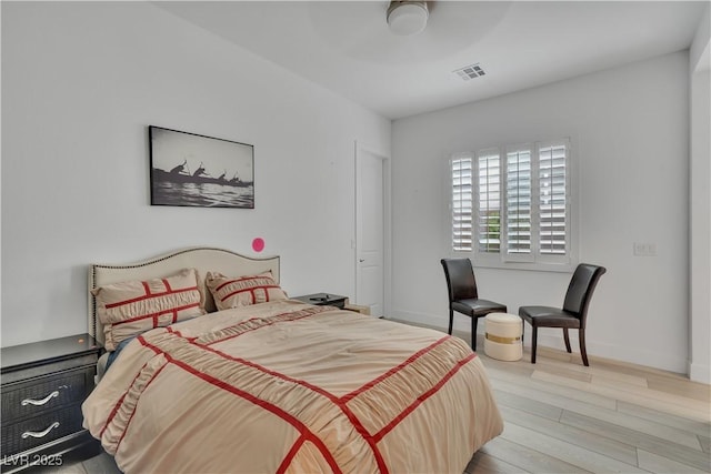 bedroom featuring baseboards, visible vents, and light wood-style floors