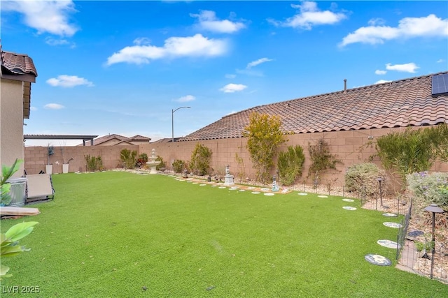 view of yard with a fenced backyard