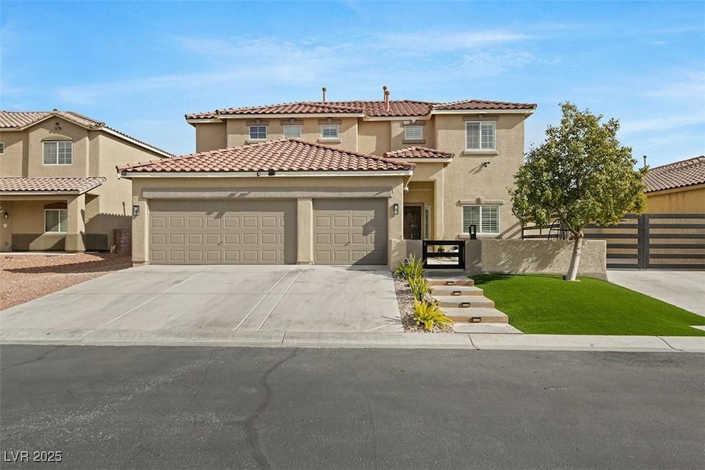 mediterranean / spanish home with an attached garage, fence, concrete driveway, and stucco siding