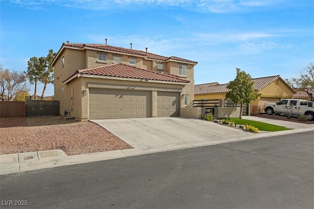 mediterranean / spanish-style home with driveway, a garage, a gate, fence, and stucco siding