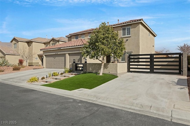 view of front of house with concrete driveway, stucco siding, a gate, fence, and a front yard