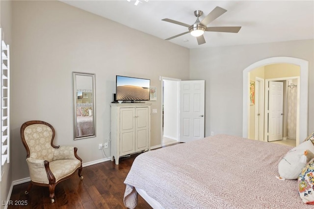 bedroom featuring arched walkways, ceiling fan, lofted ceiling, dark wood-style flooring, and baseboards