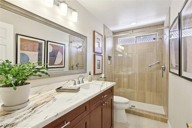 bathroom featuring a stall shower, vanity, toilet, and tile patterned floors