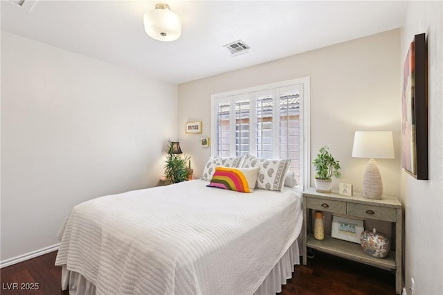 bedroom featuring dark wood-style flooring, visible vents, and baseboards