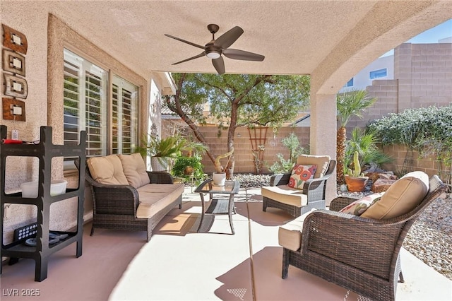 view of patio featuring outdoor lounge area, a fenced backyard, and a ceiling fan