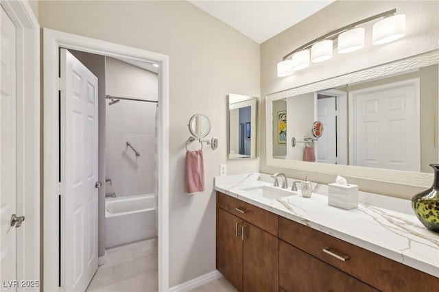 full bath featuring  shower combination, tile patterned flooring, vanity, and baseboards