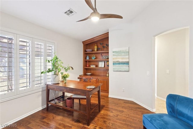 office area featuring dark wood-style flooring, visible vents, ceiling fan, and baseboards