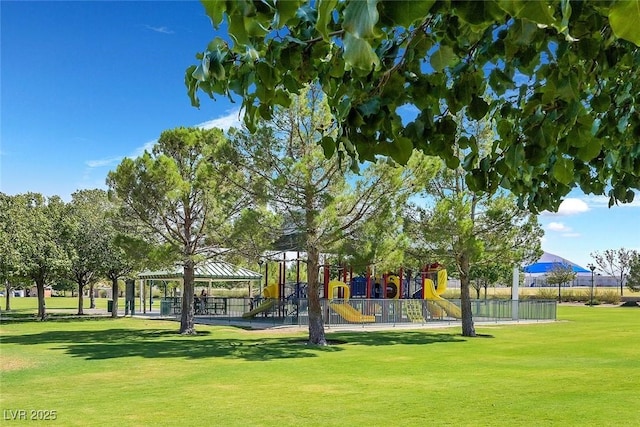 view of property's community featuring playground community and a lawn