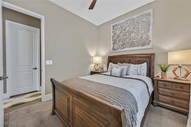 carpeted bedroom with ceiling fan and baseboards