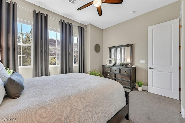 bedroom featuring baseboards, carpet floors, visible vents, and a ceiling fan