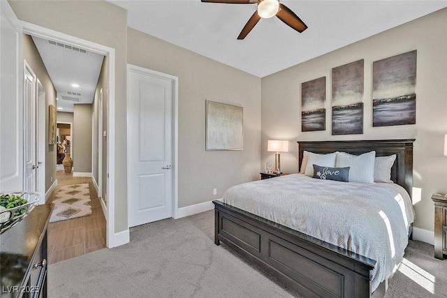 bedroom with visible vents, baseboards, ceiling fan, and light colored carpet