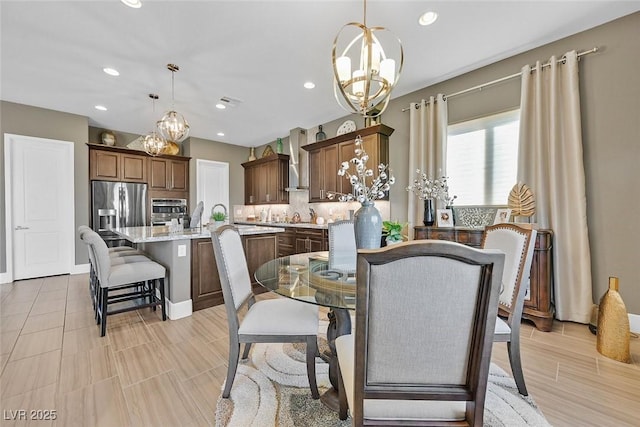 dining space with recessed lighting and an inviting chandelier