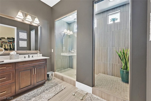 full bathroom featuring walk in shower and vanity