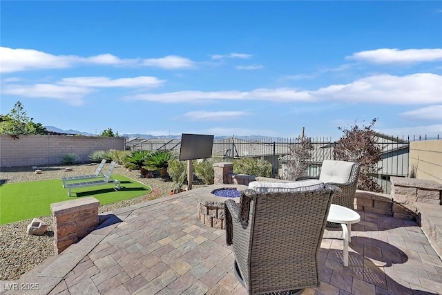 view of patio / terrace with an outdoor fire pit and a fenced backyard