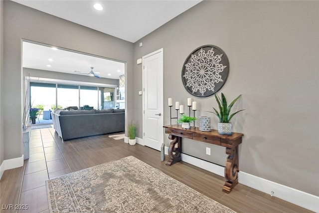 interior space featuring wood tiled floor, baseboards, and recessed lighting