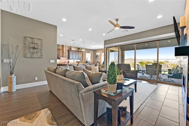 living area featuring baseboards, visible vents, a wealth of natural light, and wood finished floors