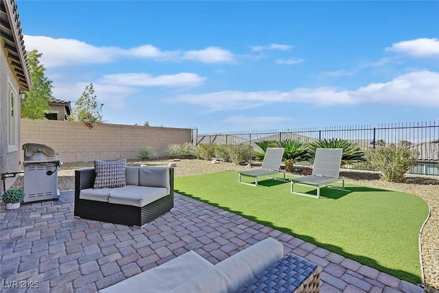 view of patio with grilling area and a fenced backyard