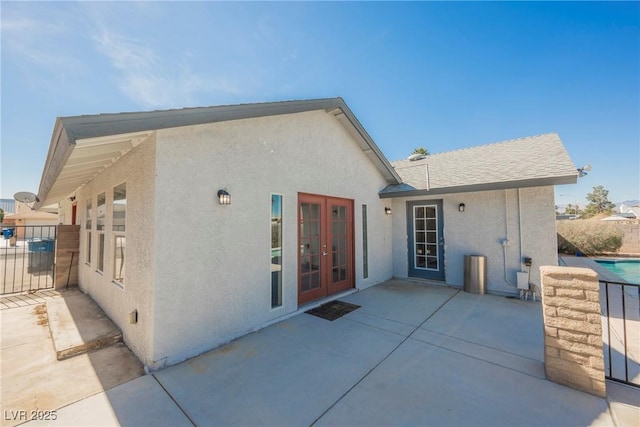 6284 Pinewood Ave, Las Vegas, NV 89103 - back of property with stucco siding, a patio area, fence, and french doors