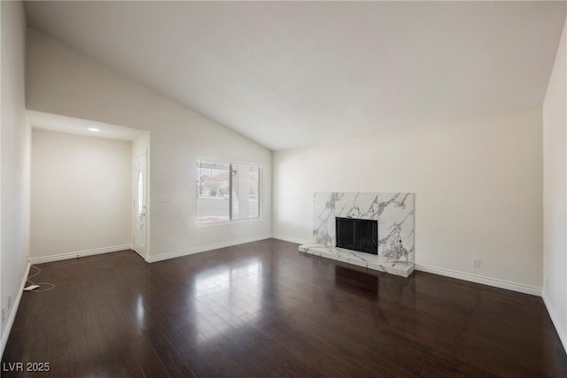 6284 Pinewood Ave, Las Vegas, NV 89103 - unfurnished living room featuring lofted ceiling, a fireplace, wood finished floors, and baseboards