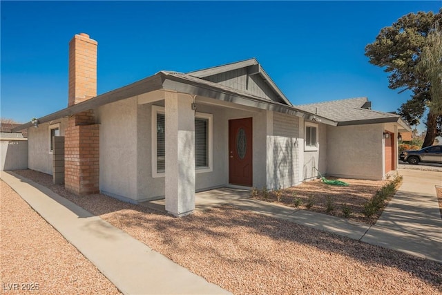 6284 Pinewood Ave, Las Vegas, NV 89103 - view of front of house featuring a garage, a chimney, and stucco siding