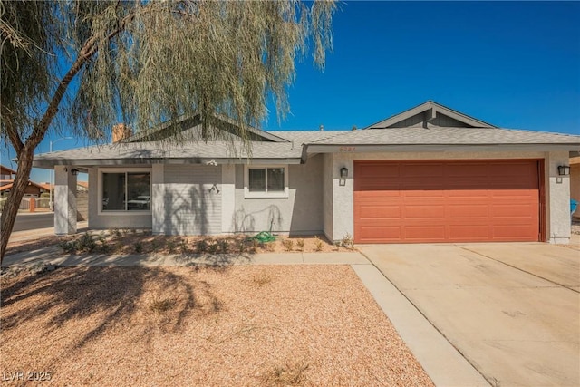 single story home featuring driveway, roof with shingles, a garage, and stucco siding