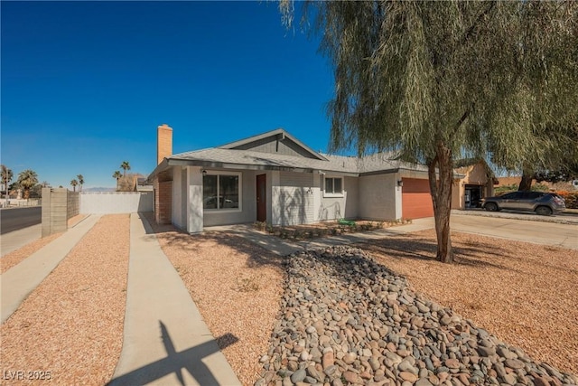 6284 Pinewood Ave, Las Vegas, NV 89103 - ranch-style home featuring driveway, a chimney, an attached garage, fence, and brick siding