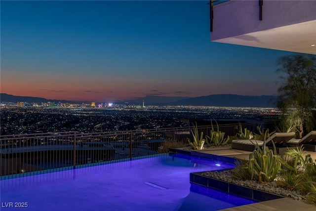 pool at dusk with an outdoor pool