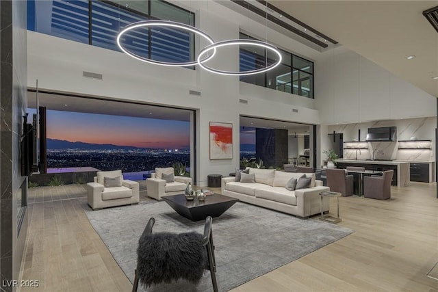 living area with visible vents and wood finished floors