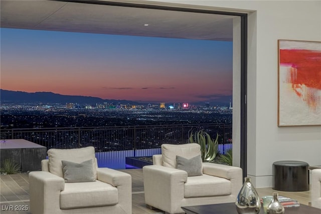 patio terrace at dusk with a balcony and an outdoor hangout area