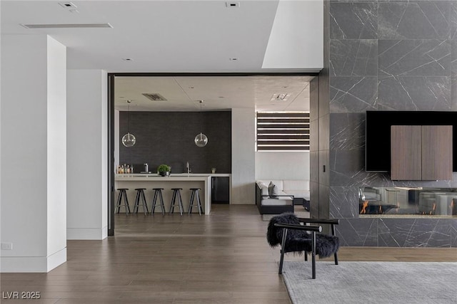 interior space with visible vents, baseboards, and wood finished floors