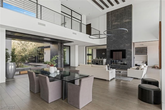 interior space with visible vents, a towering ceiling, and wood finished floors