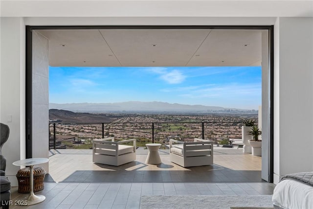 view of patio with a balcony and a mountain view