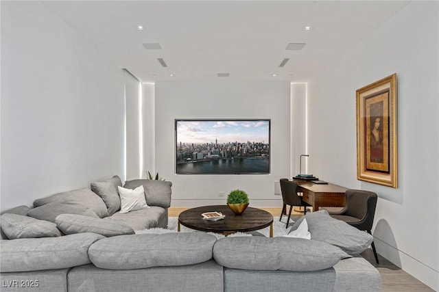 living room featuring recessed lighting, light wood-type flooring, and baseboards