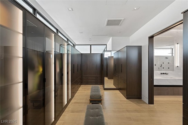 interior space featuring light wood finished floors and visible vents