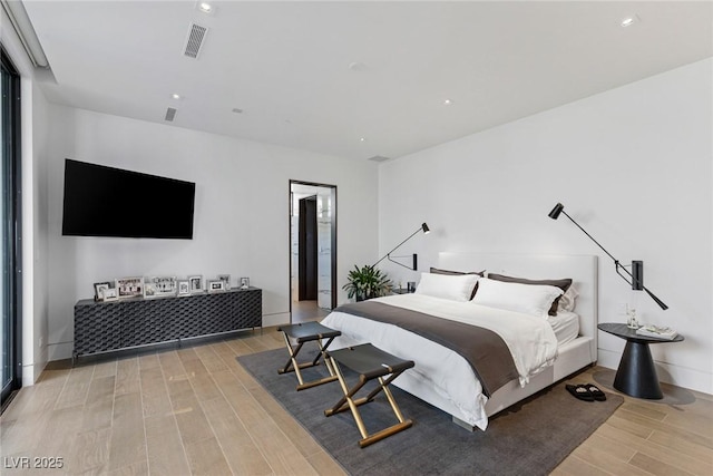 bedroom with recessed lighting, visible vents, light wood-style flooring, and baseboards