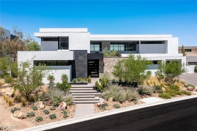 contemporary home with stone siding and stucco siding