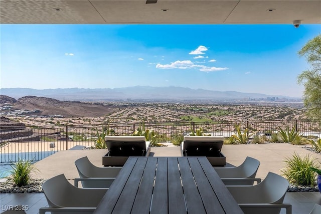 view of patio / terrace featuring a mountain view and outdoor dining area