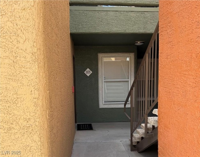 view of exterior entry featuring stucco siding