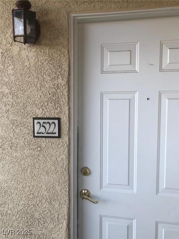 property entrance featuring stucco siding