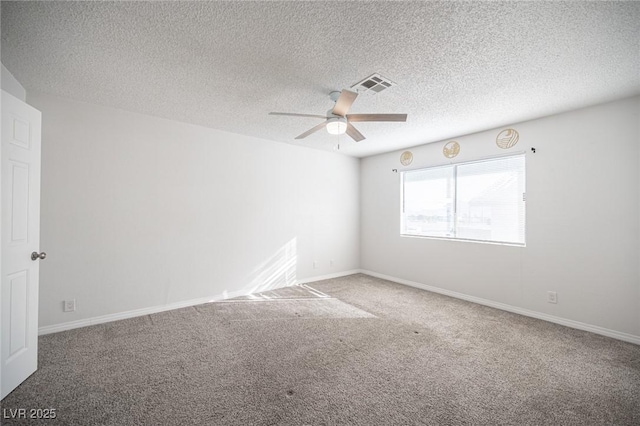 unfurnished room featuring baseboards, visible vents, a ceiling fan, carpet, and a textured ceiling