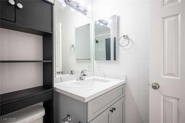 bathroom with toilet and vanity